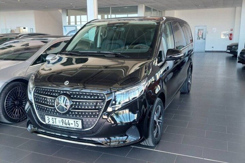 A black SUV with a visible license plate in a showroom. 3