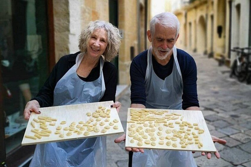 Two individuals holding boards with cookies. 3