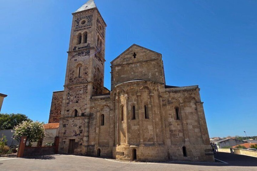 A historic stone church with a bell tower and arched windows. 4