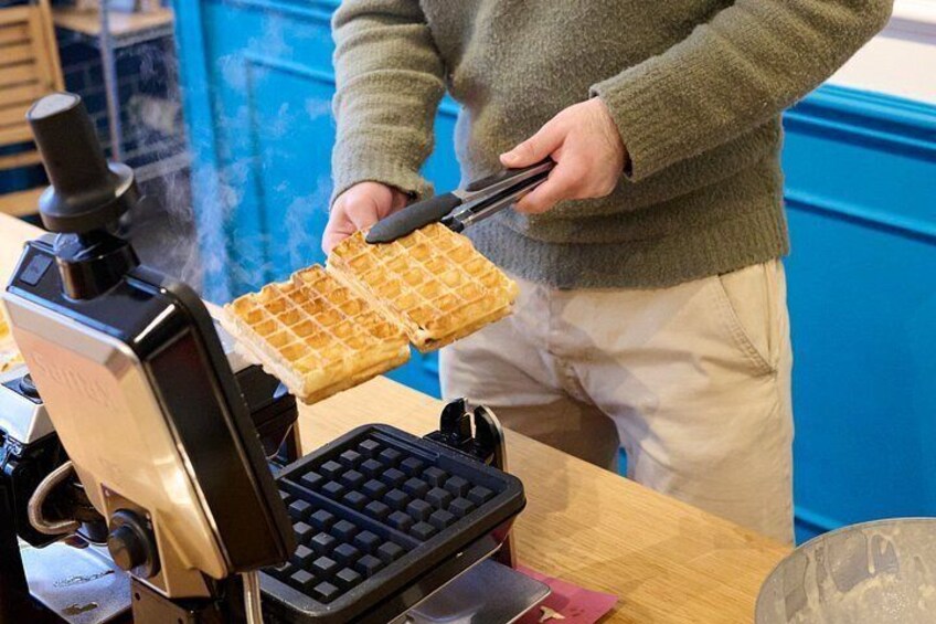 A waffle maker with waffles being cooked. 5