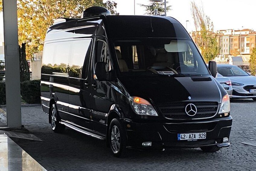 A black Mercedes van parked on a cobblestone street with a building in the background. 3