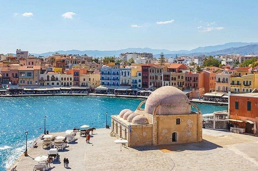 A coastal town with colorful buildings, a large dome structure, and a waterfront promenade. 4