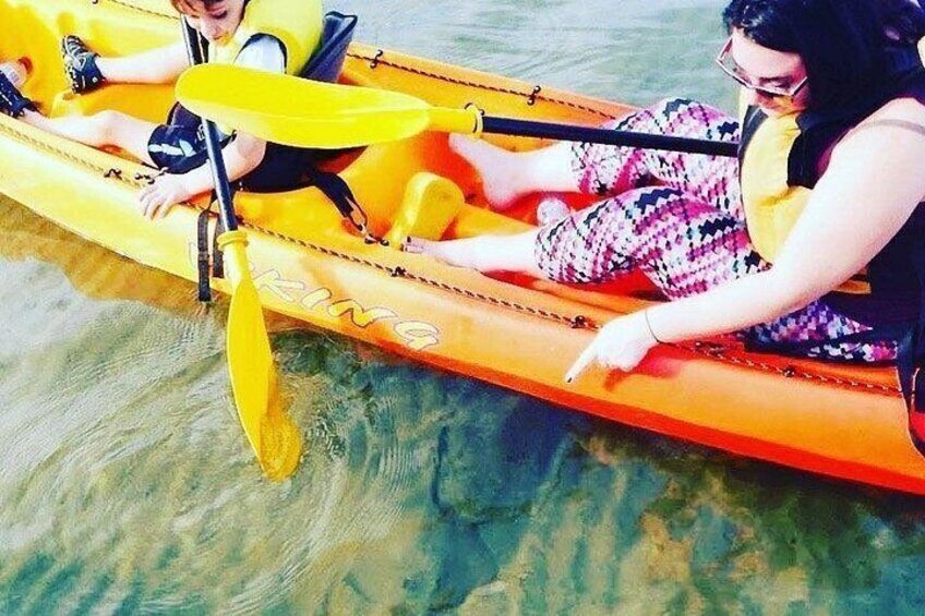 Two people in a yellow canoe on a body of water. 2