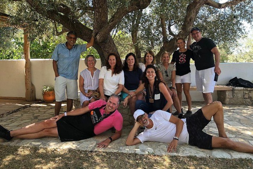 A group of people posing under a tree in an outdoor setting. 5