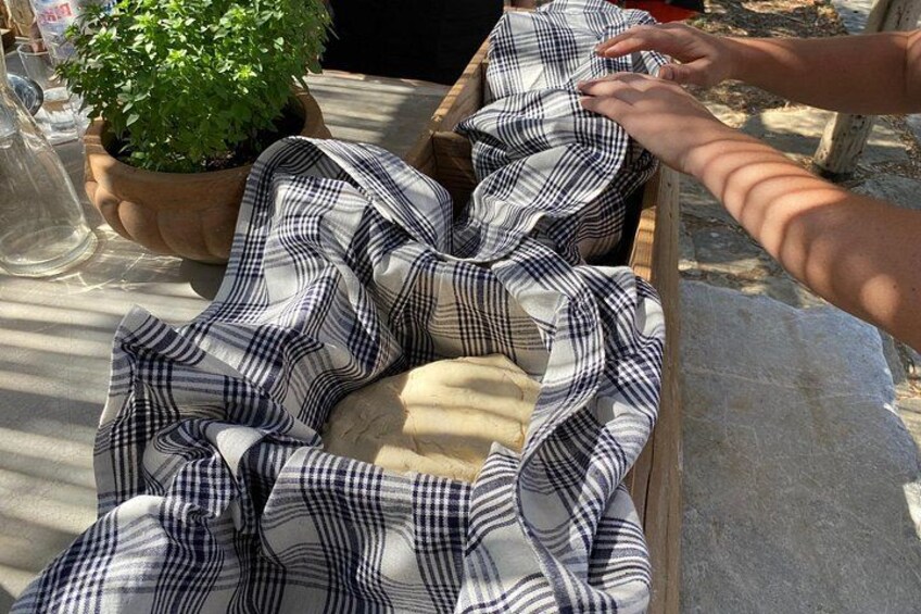 A person arranging a checkered cloth over a wooden box. 2