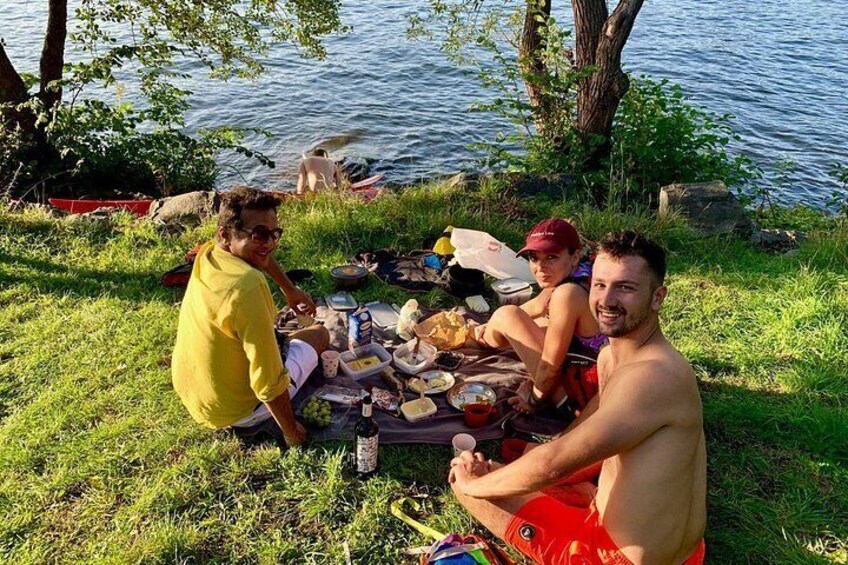 A group of people having a picnic by a lake. 1