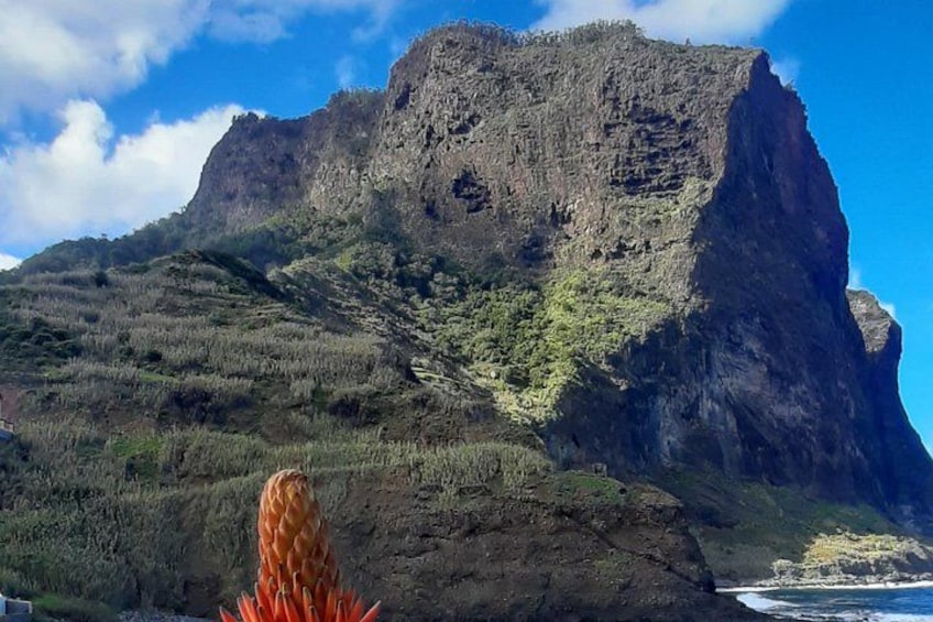 A mountain with a steep cliff and a clear sky. 4