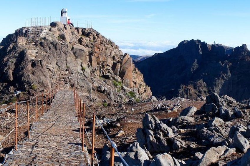 A rocky mountain path leading to a lighthouse. 2