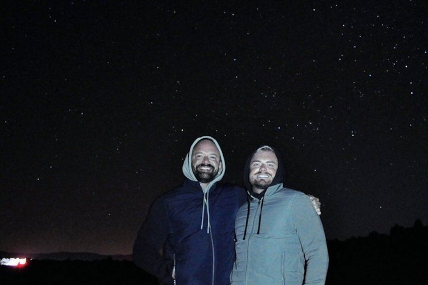 Two people standing under a starry night sky. 5
