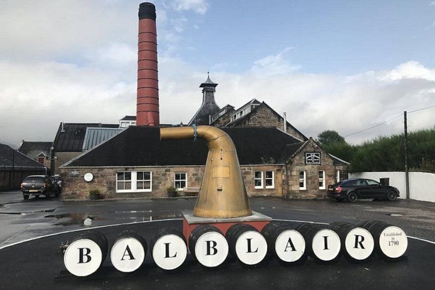 A building with a chimney, a large gold pipe, and the name 'BALBLAIR' on the ground. 4