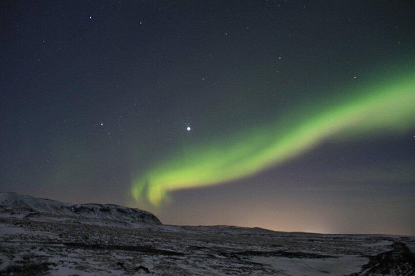 A snowy landscape with the Northern Lights. 2