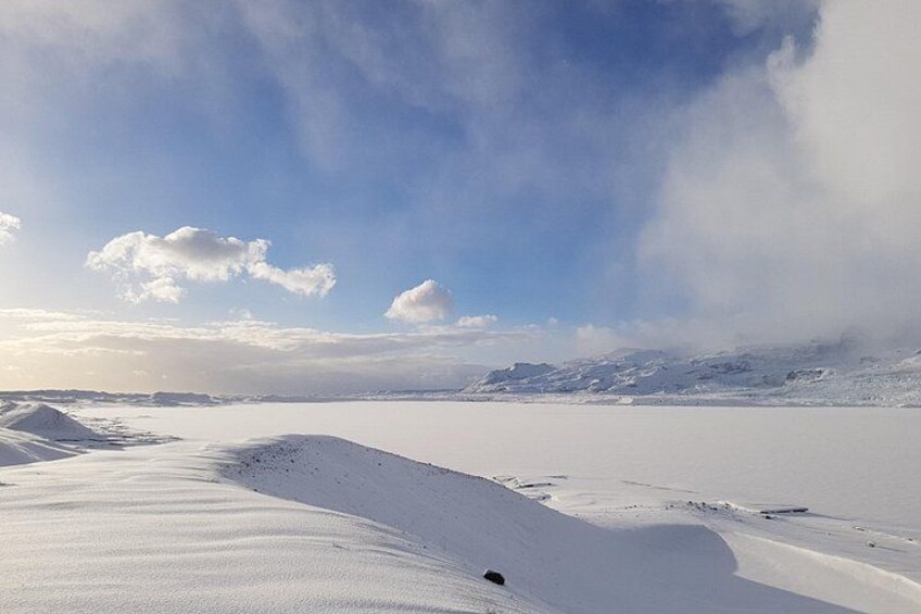 A snowy landscape with a clear sky and distant mountains. 5