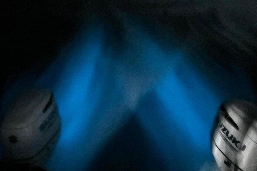 A dark scene with blue light beams and two objects with 'ZUKI' text. 4
