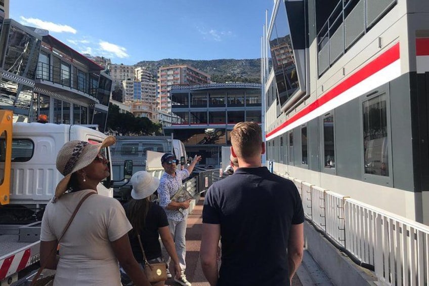 A ferry with passengers boarding, a cityscape with buildings in the background, and a clear sky. 1
