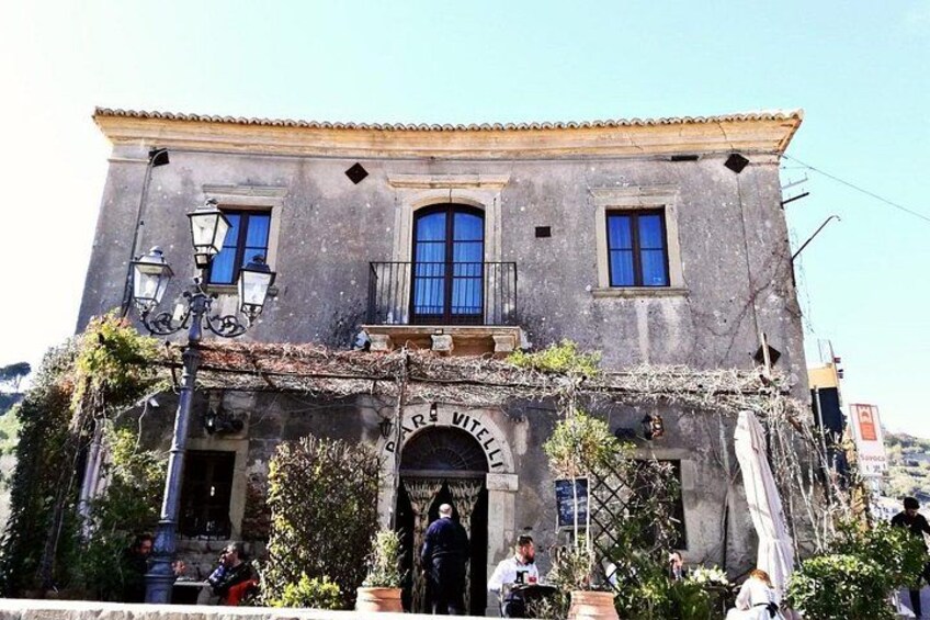 A building with a sign reading 'Piazza Vittorio.' 4