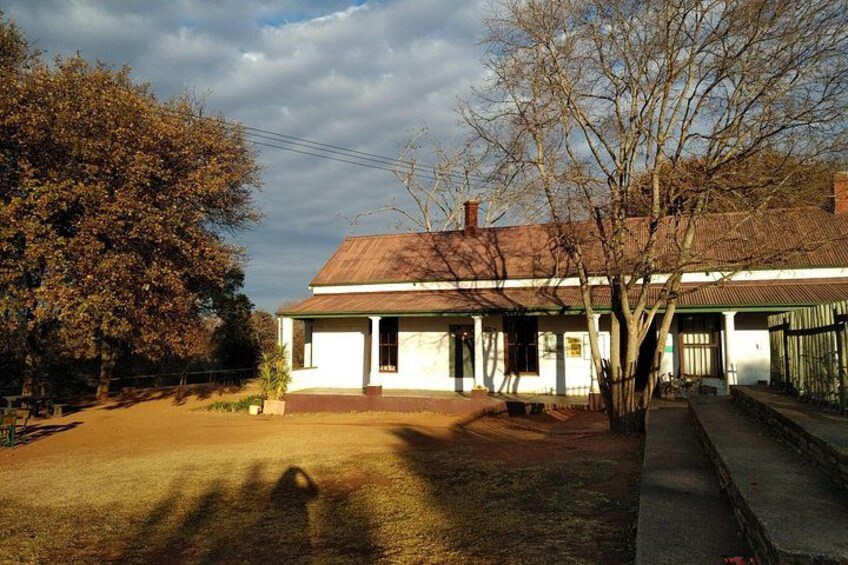 A house with a red roof, surrounded by trees and a clear sky. 3