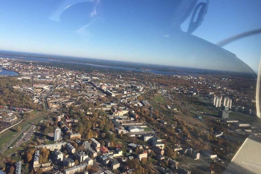 An aerial view of a city with a river, buildings, and a large body of water. 4