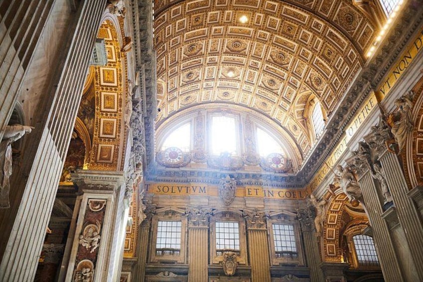 An ornate interior with a domed ceiling, columns, and intricate wall decorations. 2
