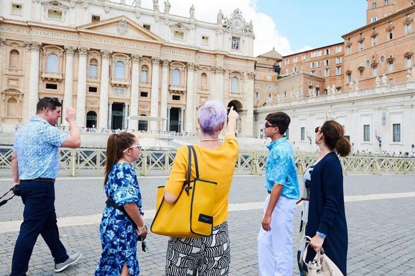 Tourists taking photos in front of a grand historical building with columns and statues. 2