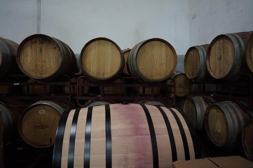 Wooden barrels stacked in a warehouse. 3