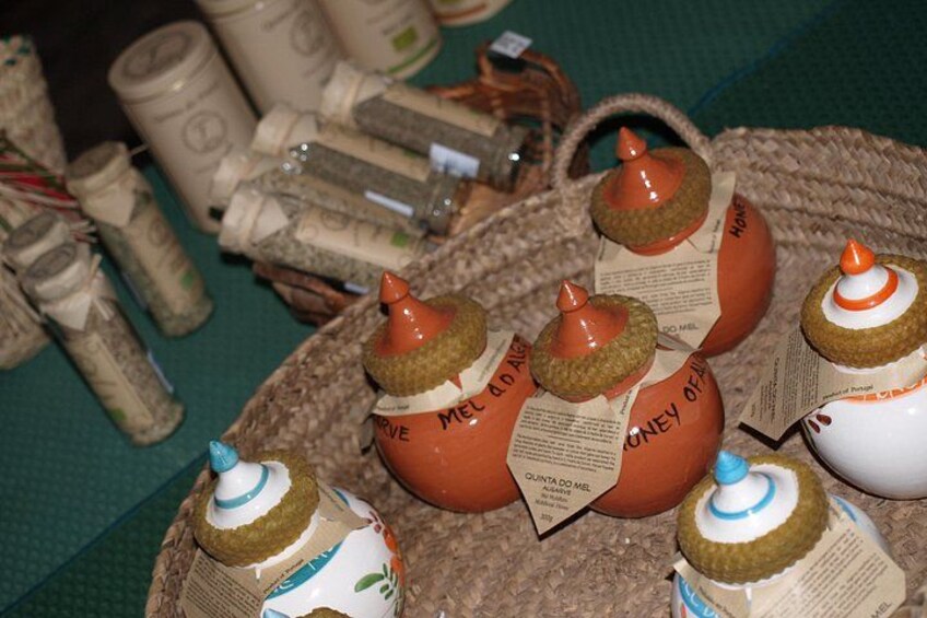 Ceramic jars with labels, arranged on a woven mat. 3