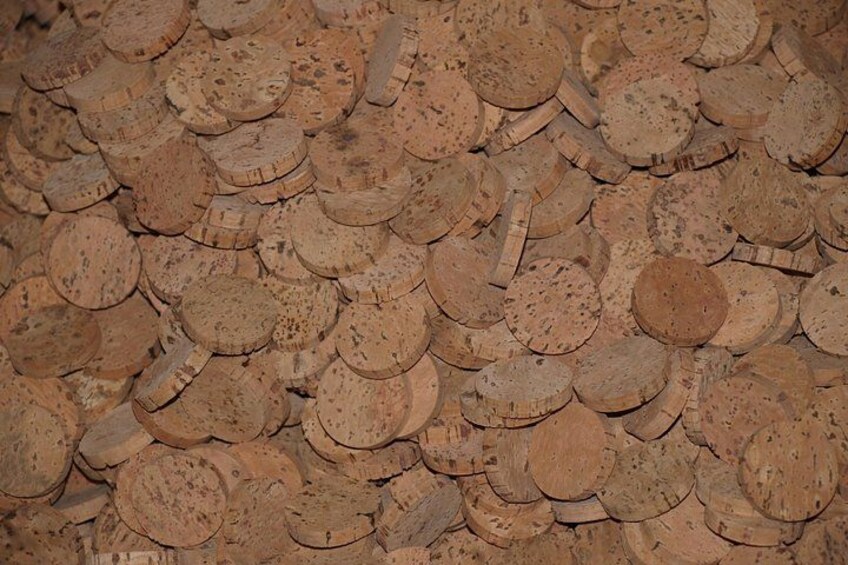 A collection of wooden discs, possibly corks, stacked closely together. 2