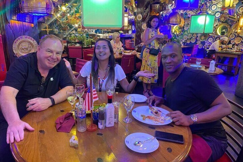 A group of people dining at a restaurant with a festive, decorated interior. 2
