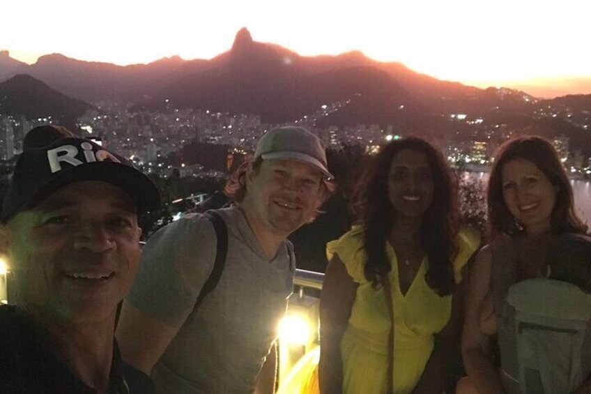 A group of people standing with a cityscape and mountains in the background. 3