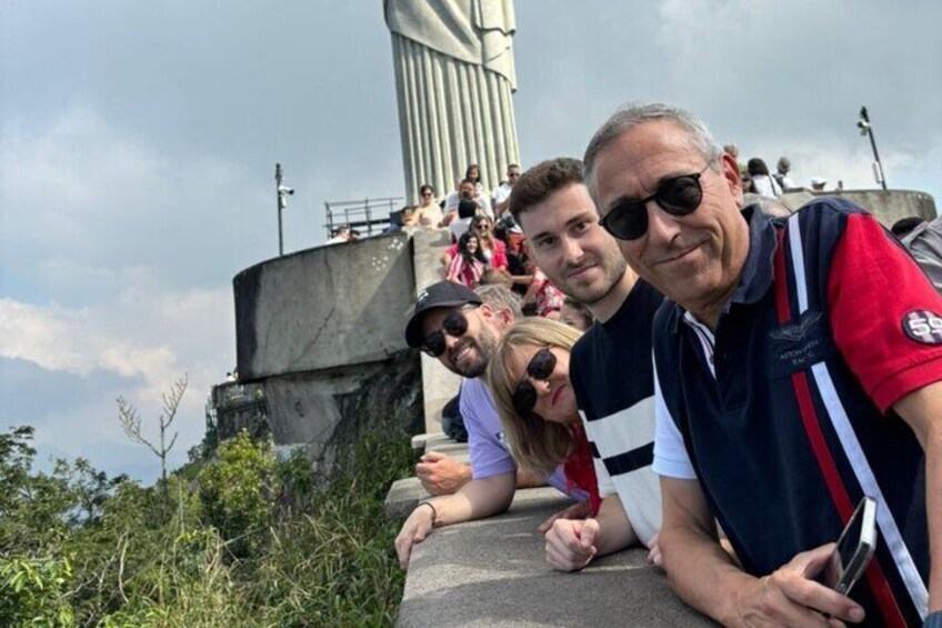 A group of people at a historical monument with a large, vertical structure in the background. 5