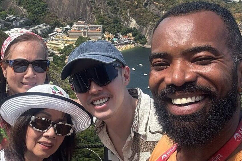 A group of people with a mountainous landscape and a body of water in the background. 4