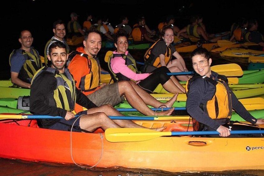 People in kayaks on a water body. 1
