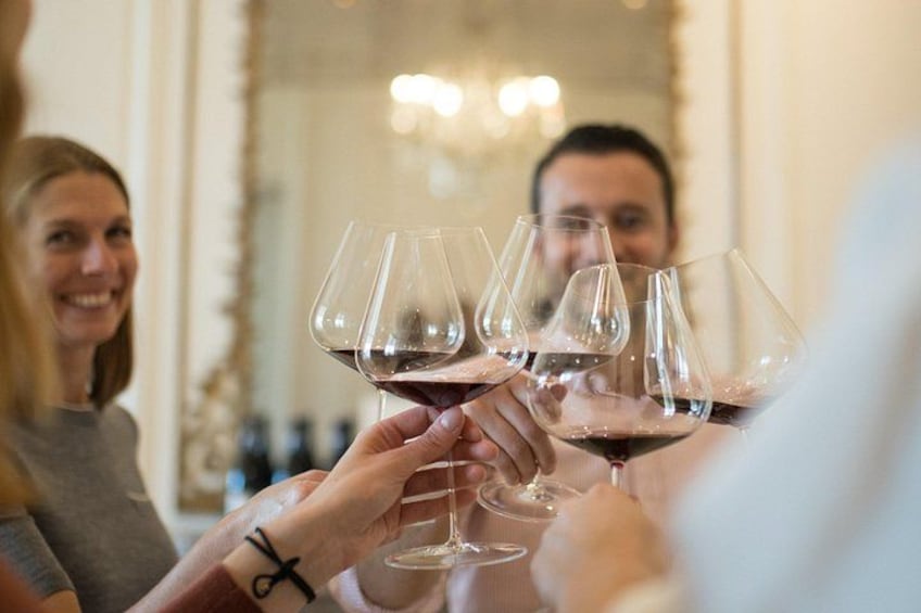 A group of people toasting with wine glasses. 2
