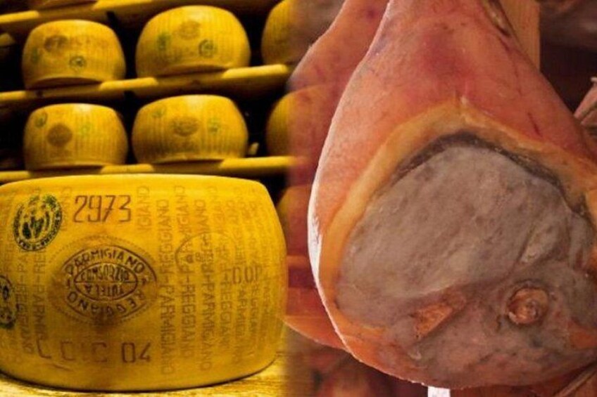 A wheel of cheese with a label and a piece of meat. 1