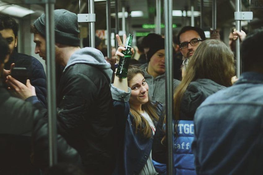 A crowded subway train with passengers holding onto poles. 5