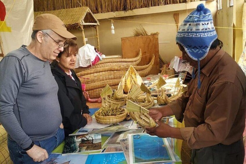 A person displaying woven baskets at a market stall. 2