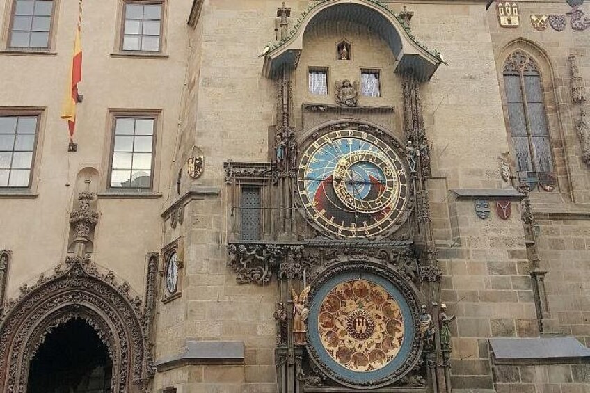 A building with a large, ornate clock and a smaller clock below it. 5