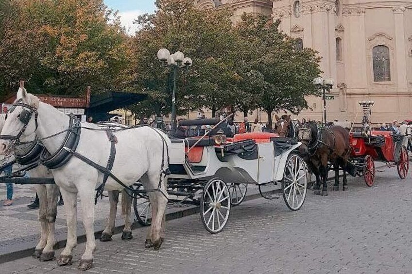 A street with horse-drawn carriages. 3