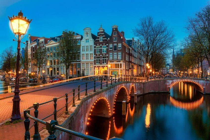 Un canal con un puente, edificios históricos y un farol. 3