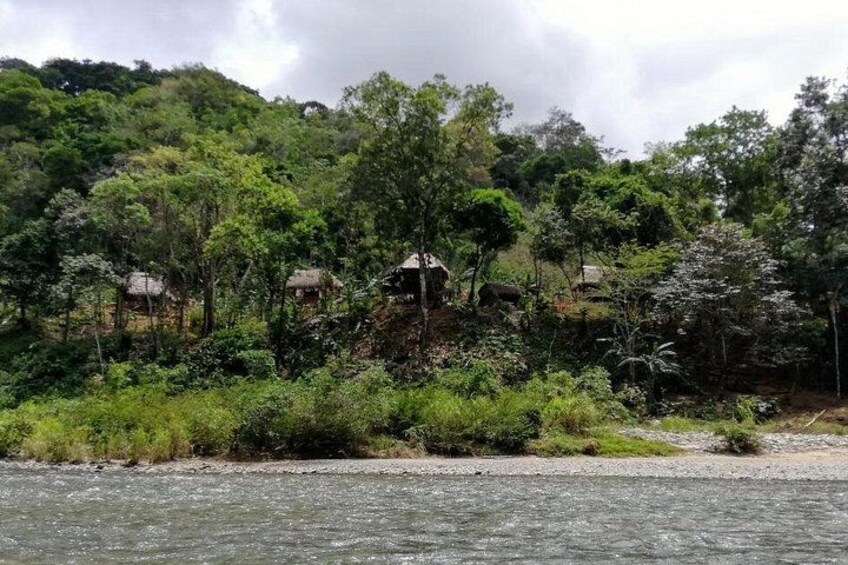 A river with houses on a hillside. 2