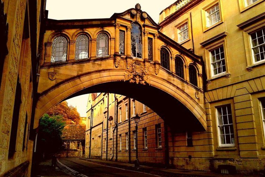 An arched stone bridge with ornate details, connecting two buildings. 4