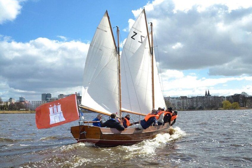 A traditional sailing boat with two sails on a river. 3