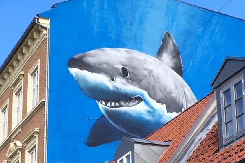 A large shark mural on a building. 3