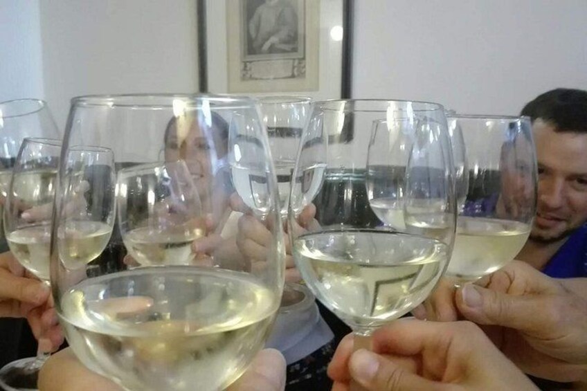 A group of people holding wine glasses. 4