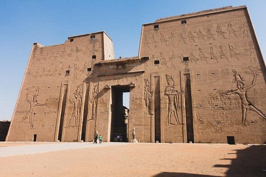 An ancient Egyptian temple with hieroglyphs and statues. 5