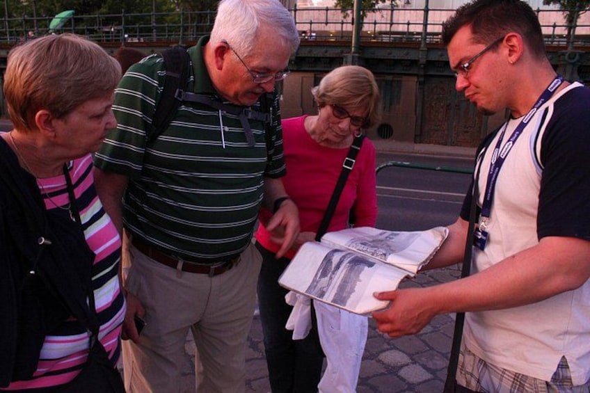 A group of people examining a map or guidebook. 4