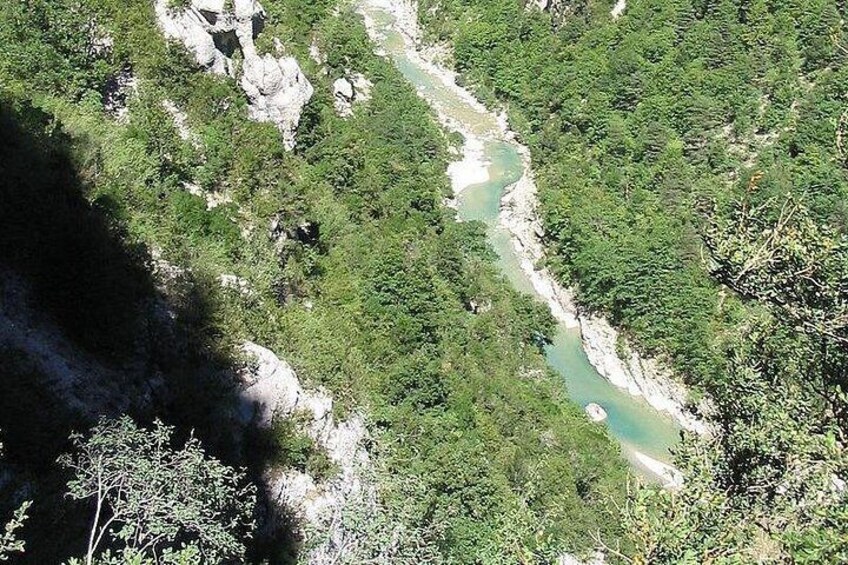 A river winding through a forested valley with rocky outcrops. 3