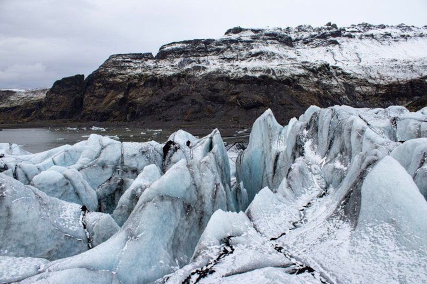 A glacier with icebergs in a rocky landscape. 4