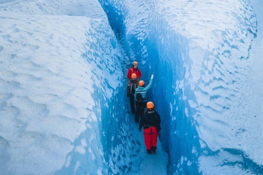 A group of people in a narrow, icy passage. 4