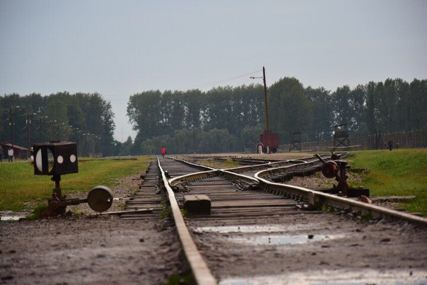 Railway tracks with a signal box and a distant red building. 3