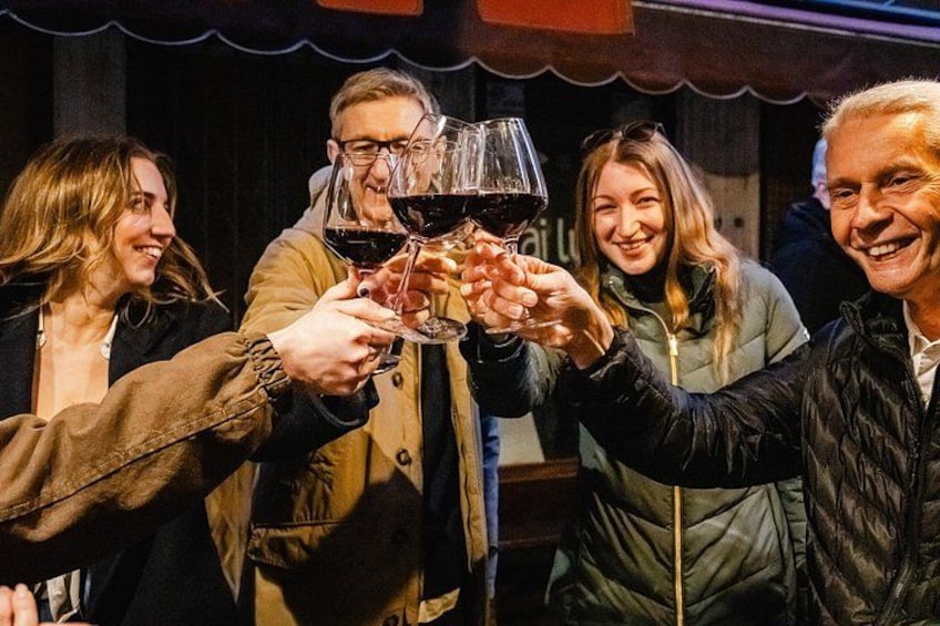 A group of people toasting with wine glasses. 5
